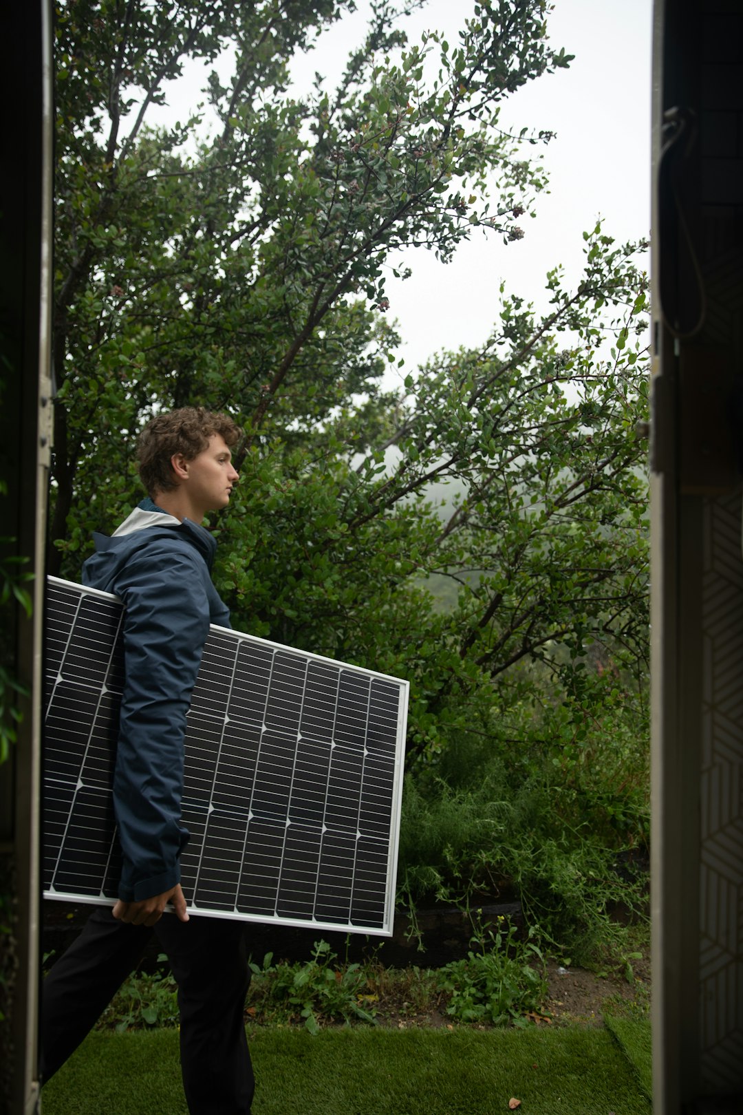 services-04 a-man-carrying-a-solar-panel-on-his-back-5d-ei2dgxy4
